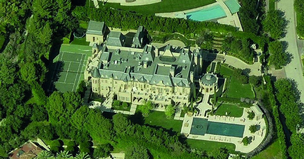 Twilight exterior of a large estate with pool