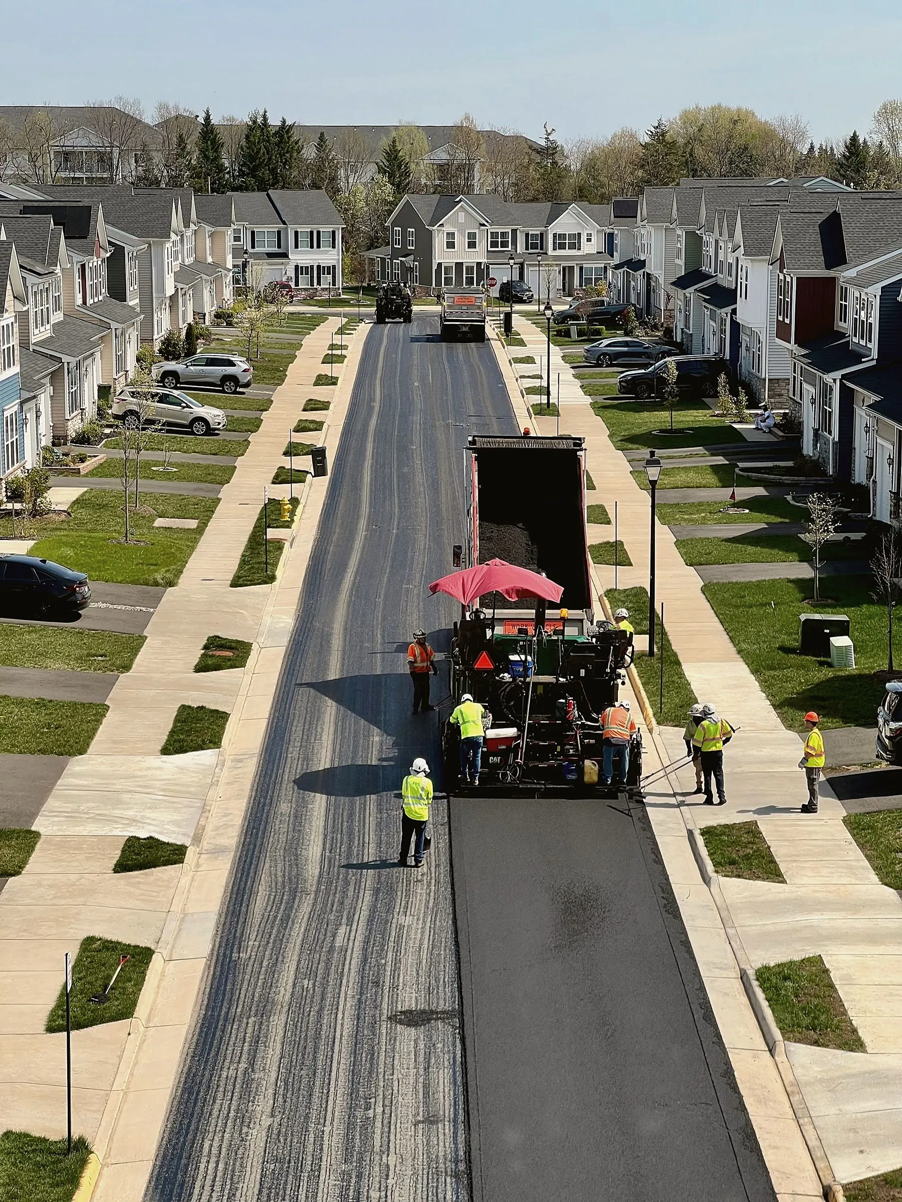 Paving crew resurfacing a residential street
