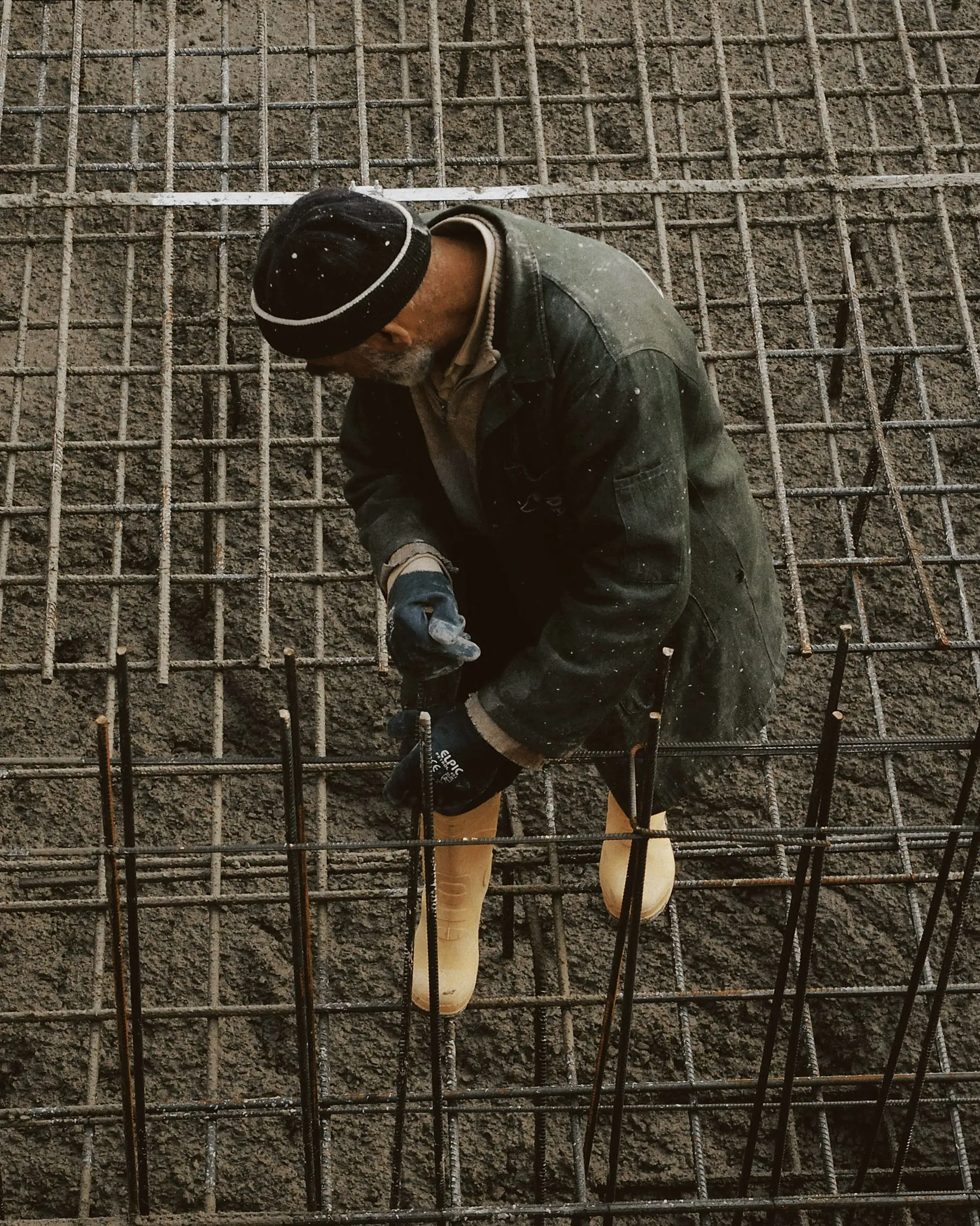 Ironworker tying rebar on a foundation mat